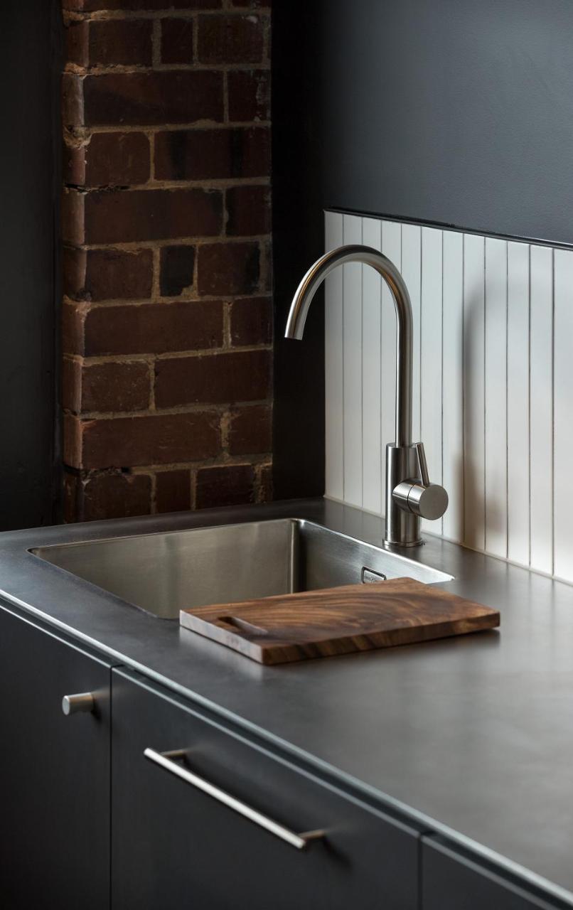 Hotel The Chamberson Dunedin Exterior foto A kitchen sink with a wooden cutting board